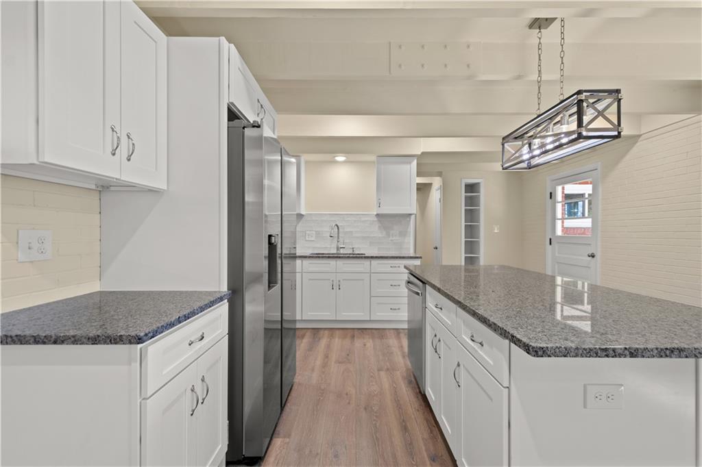 27 North Johnson Road Houston, PA 15342 - Photo 4 of 25 a kitchen with granite countertop a sink stove and cabinets