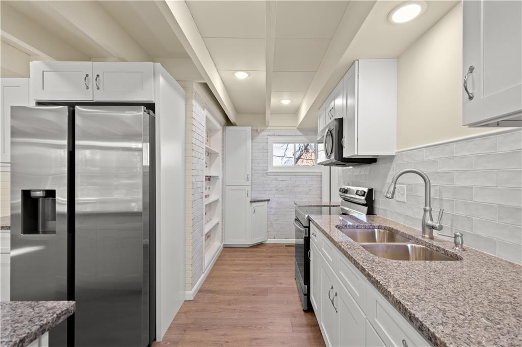 27 North Johnson Road Houston, PA 15342 - Photo 5 of 25 a kitchen with stainless steel appliances granite countertop a refrigerator a sink a stove and white cabinets