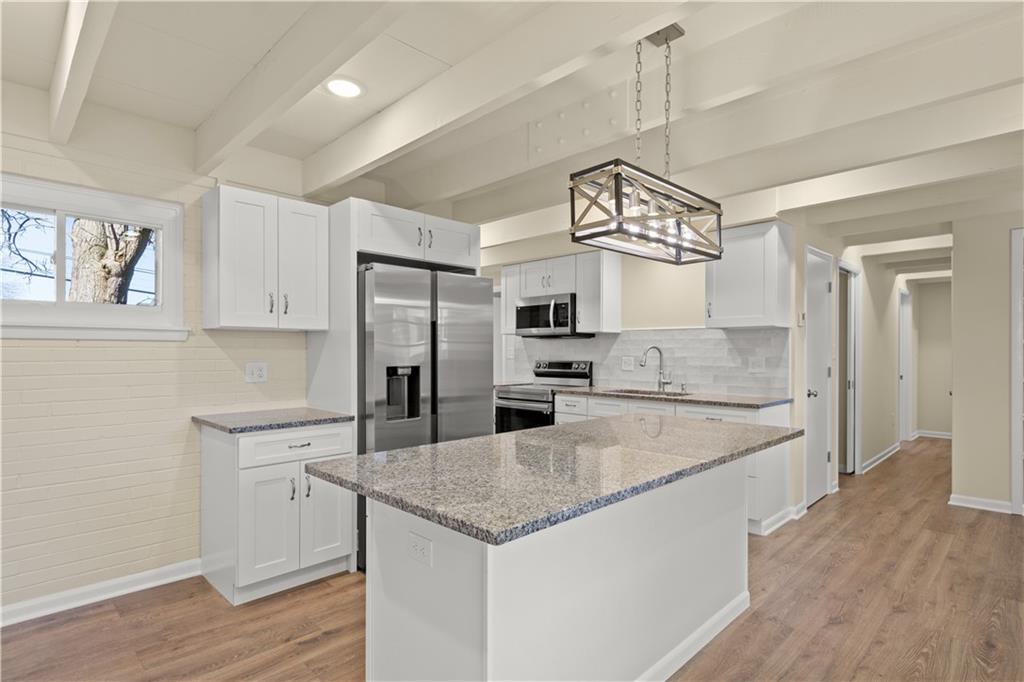 27 North Johnson Road Houston, PA 15342 - Photo 6 of 25 a kitchen with stainless steel appliances granite countertop a sink dishwasher and a refrigerator with wooden floor