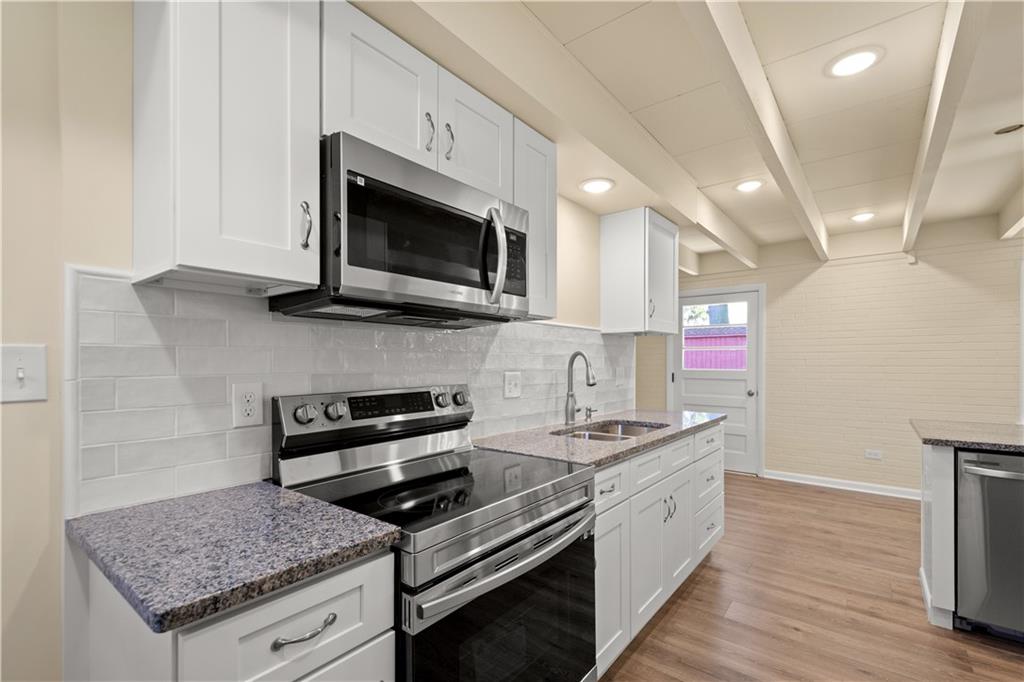 27 North Johnson Road Houston, PA 15342 - Photo 8 of 25 a kitchen with stainless steel appliances granite countertop a stove and a microwave