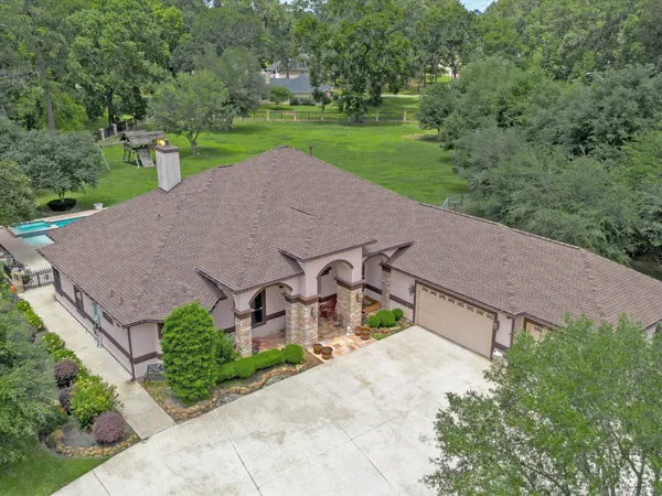 an aerial view of a house with a yard