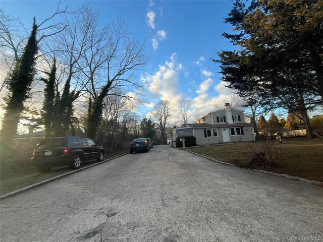 a view of a street with a cars parked on the roadside