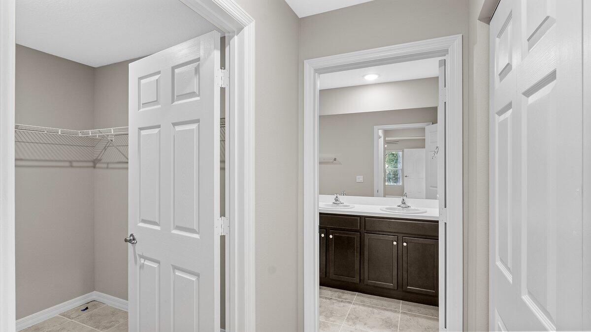 1213 Ragen Road Southeast Palm Bay, FL 32909 - Photo 16 of 26 a en suite bathroom with a sink a mirror and a shower