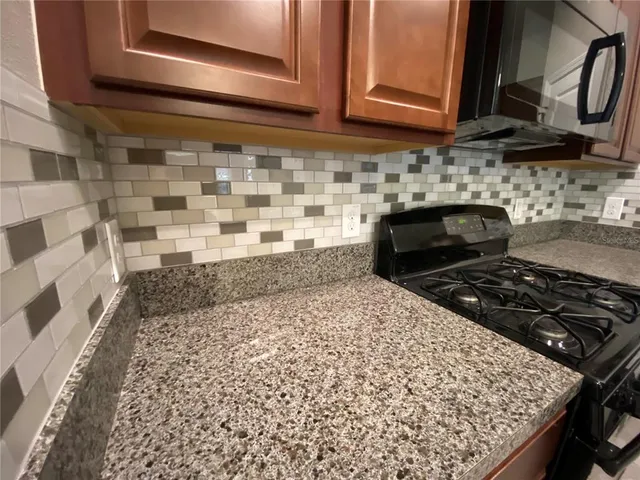 a kitchen with wooden cabinets and a stove top oven