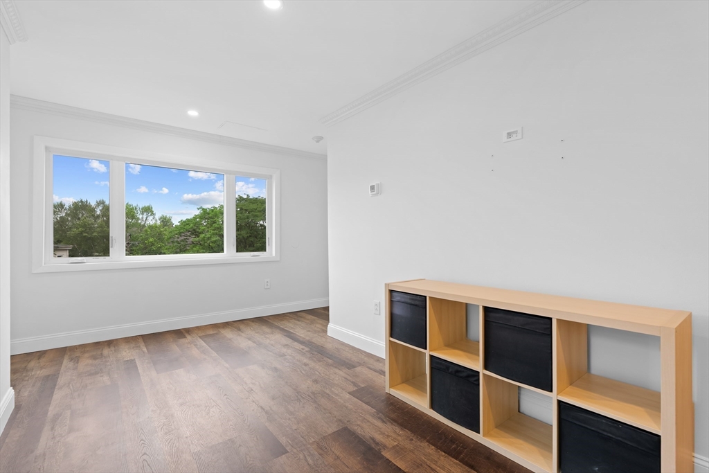 35 Des Moines Road, Unit 310 Quincy, MA 02169 - Photo 11 of 22 a view of an empty room with wooden floor and windows