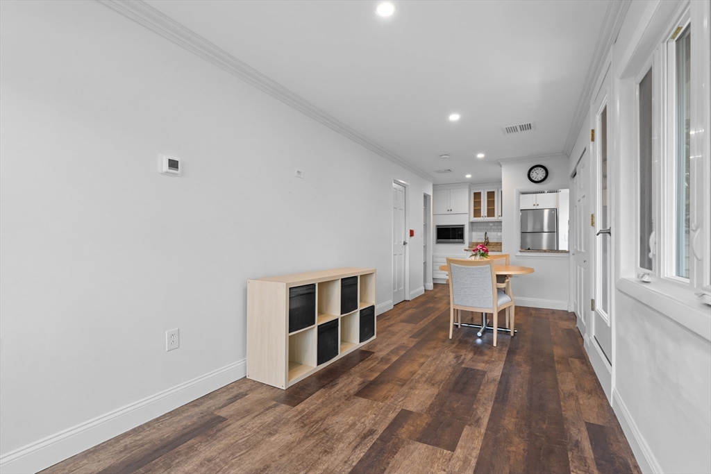 35 Des Moines Road, Unit 310 Quincy, MA 02169 - Photo 14 of 22 a open kitchen with stainless steel appliances granite countertop a stove and a wooden floors