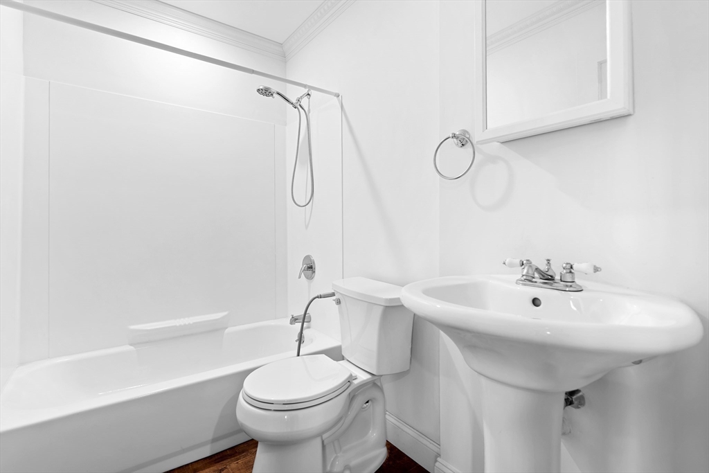 35 Des Moines Road, Unit 310 Quincy, MA 02169 - Photo 19 of 22 a bathroom with a sink a toilet and shower