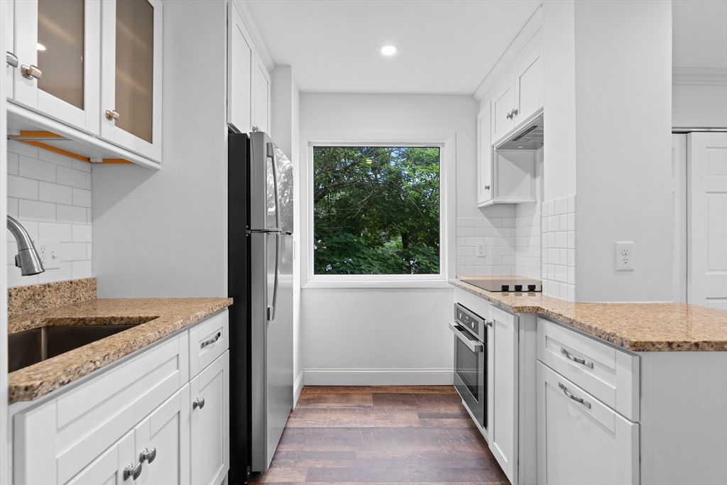 35 Des Moines Road, Unit 310 Quincy, MA 02169 - Photo 3 of 22 a kitchen with a sink stove and refrigerator