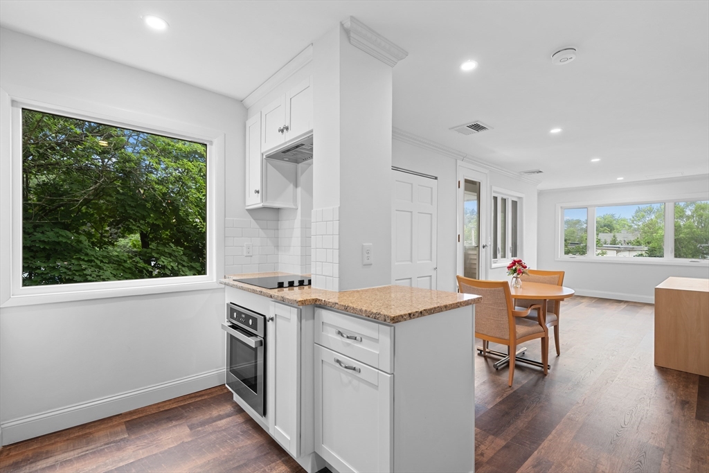 35 Des Moines Road, Unit 310 Quincy, MA 02169 - Photo 4 of 22 a kitchen that has a sink a table and chairs in it