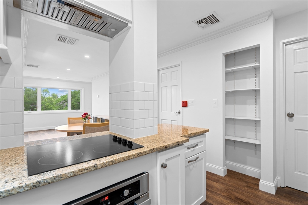 35 Des Moines Road, Unit 310 Quincy, MA 02169 - Photo 6 of 22 a kitchen with a sink cabinets and wooden floor
