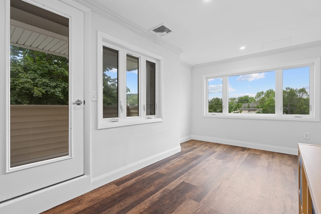 35 Des Moines Road, Unit 310 Quincy, MA 02169 - Photo 9 of 22 a view of an empty room with wooden floor and a window