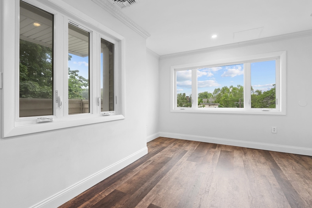 35 Des Moines Road, Unit 310 Quincy, MA 02169 - Photo 10 of 22 a view of an empty room with wooden floor and a window