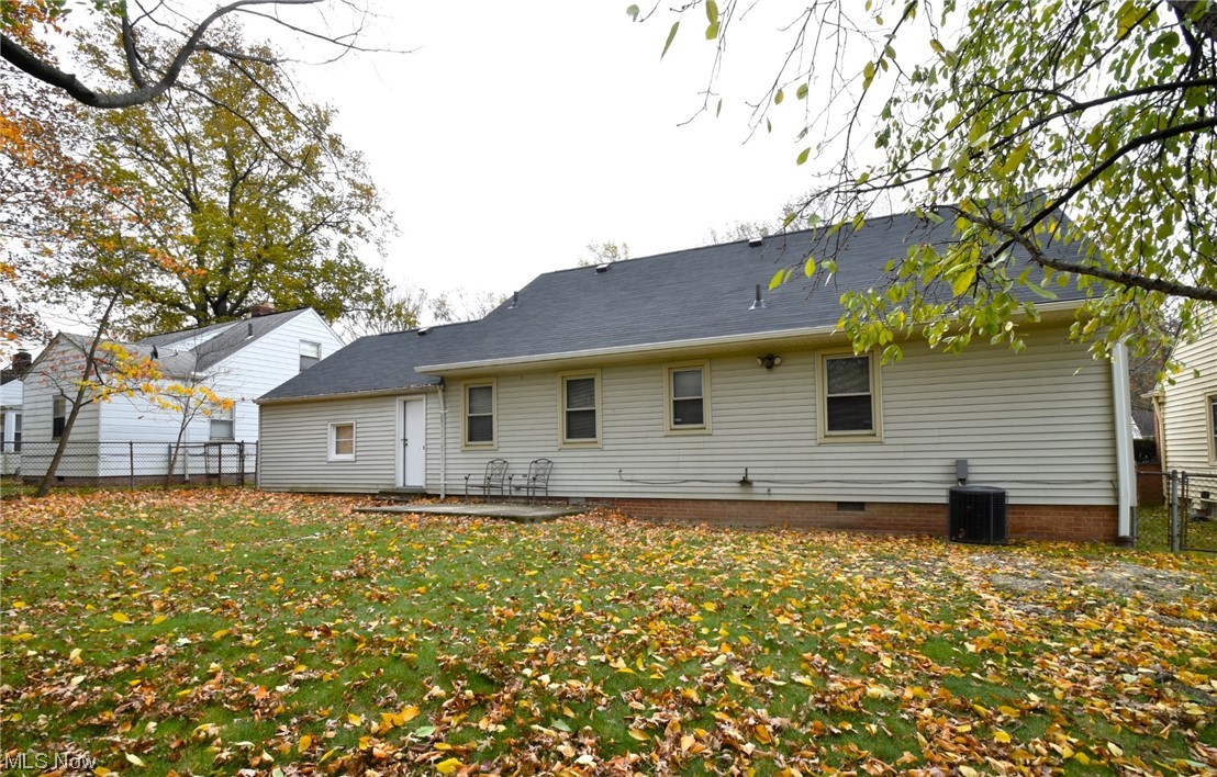 3681 Brinkmore Road Cleveland Heights, OH 44121 - Photo 26 of 27 Rear view of house with a lawn and central AC unit