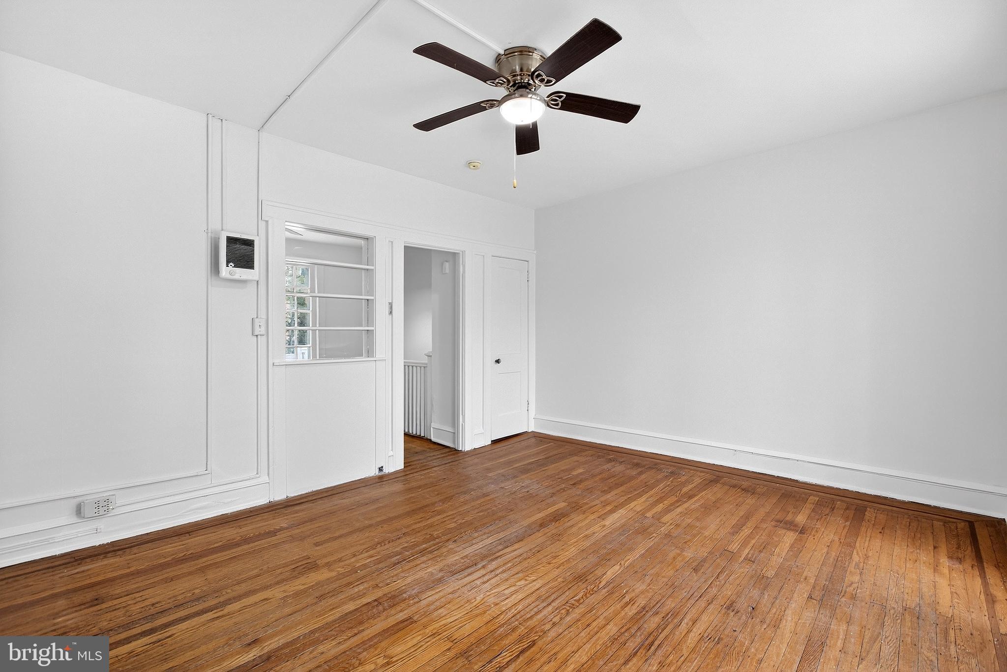 412 West Maple Avenue Merchantville, NJ 08109 - Photo 37 of 58 an empty room with wooden floor and a ceiling fan