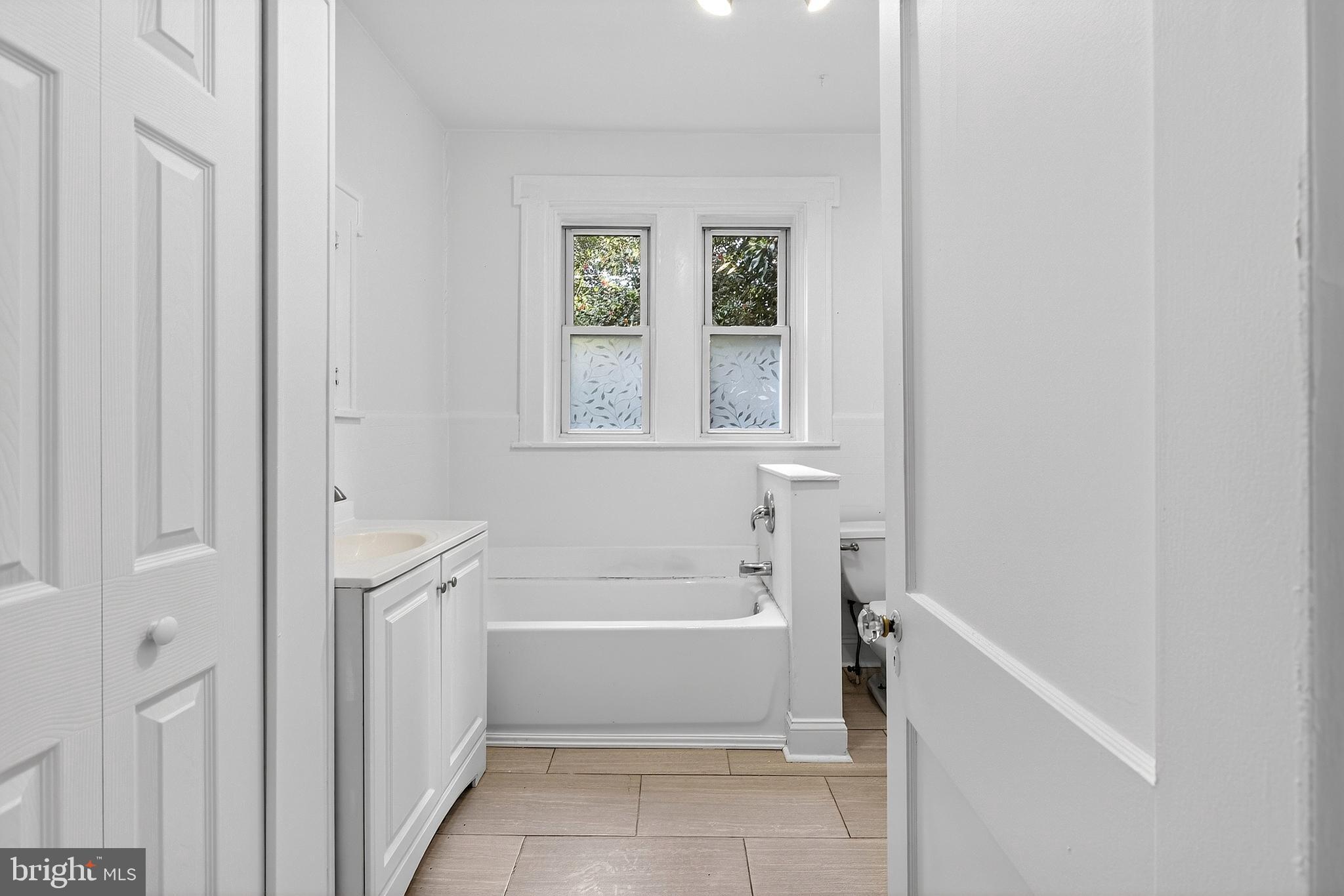 412 West Maple Avenue Merchantville, NJ 08109 - Photo 40 of 58 a bathroom with a tub shower and a window