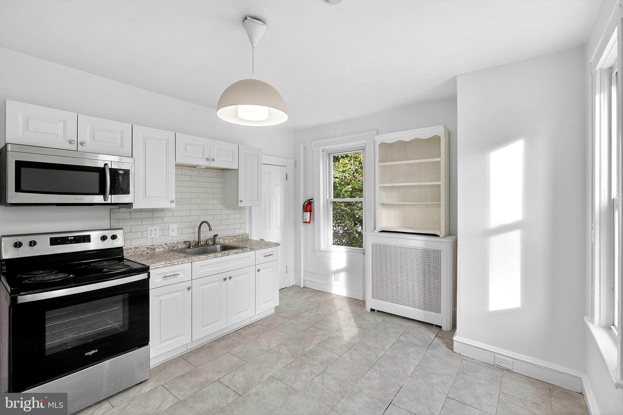 412 West Maple Avenue Merchantville, NJ 08109 - Photo 49 of 58 a kitchen with stainless steel appliances a stove a sink and a refrigerator