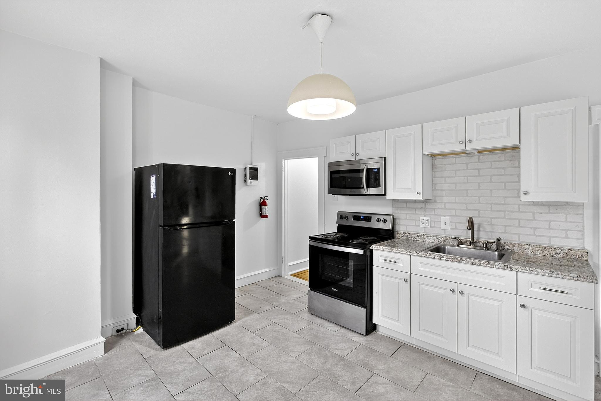 412 West Maple Avenue Merchantville, NJ 08109 - Photo 51 of 58 a kitchen with stainless steel appliances granite countertop a refrigerator and a stove