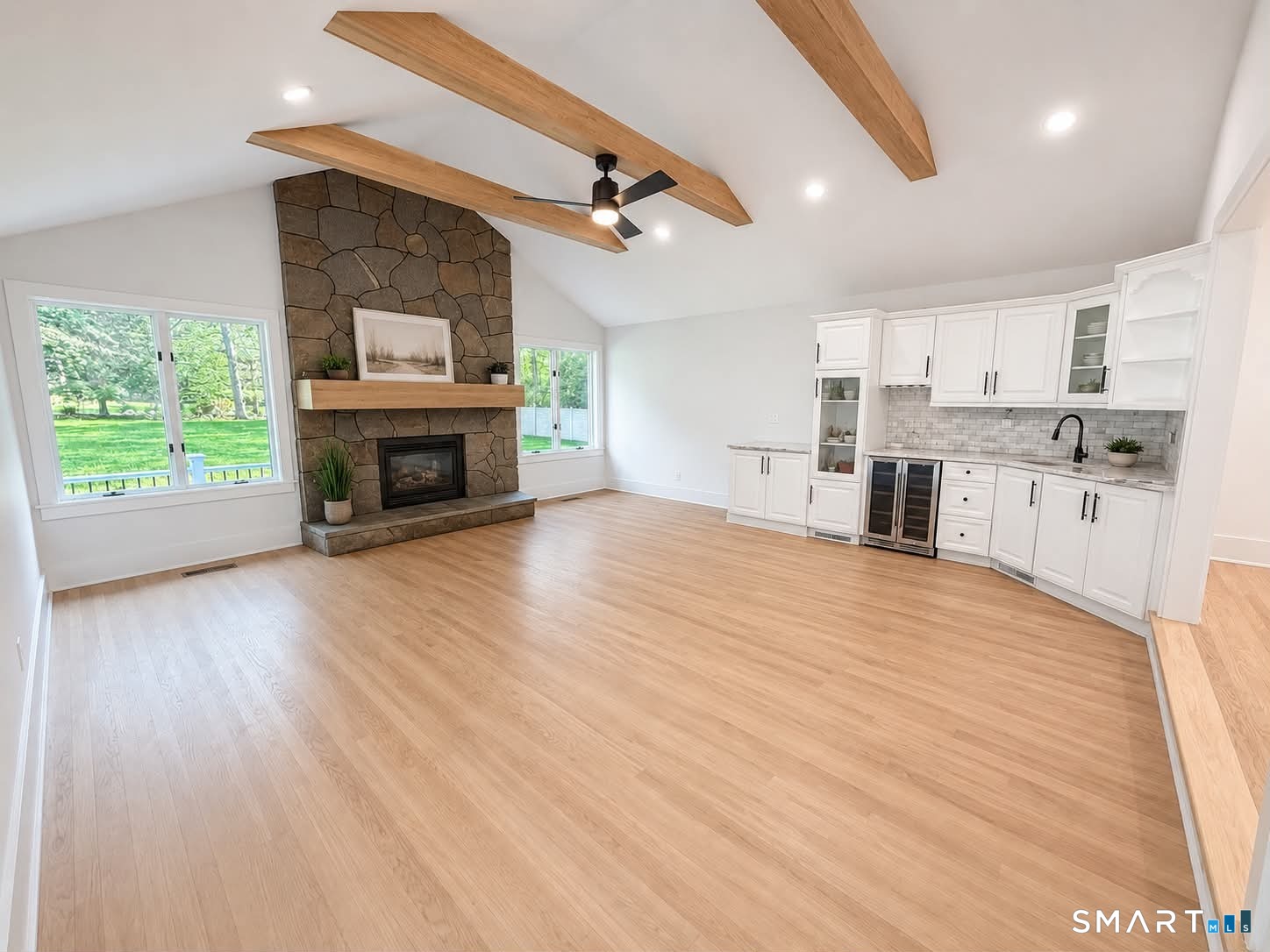 29 Flint Rock Road Stamford, CT 06903 - Photo 7 of 34 Family Room with exposed beams, wet bar, and (1st) wood-burning masonry fireplace. Sliding doors off the Family Room lead to the patio.