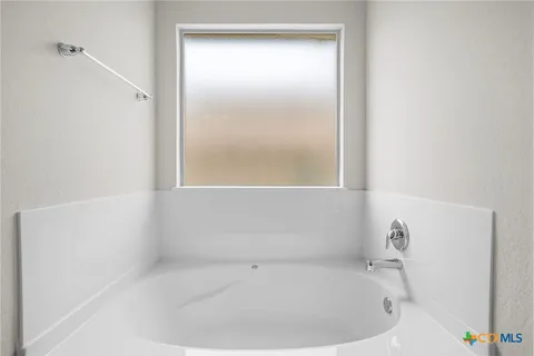 a en suite bathroom with double sink and a mirror