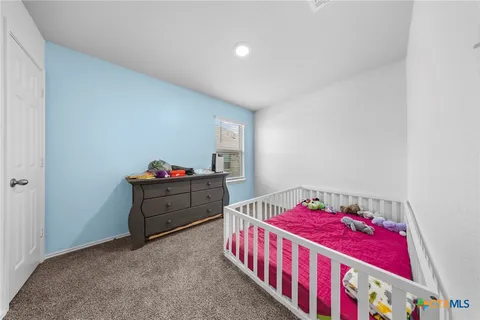 a bedroom with furniture and a window