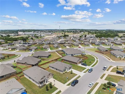 an aerial view of residential houses with outdoor space