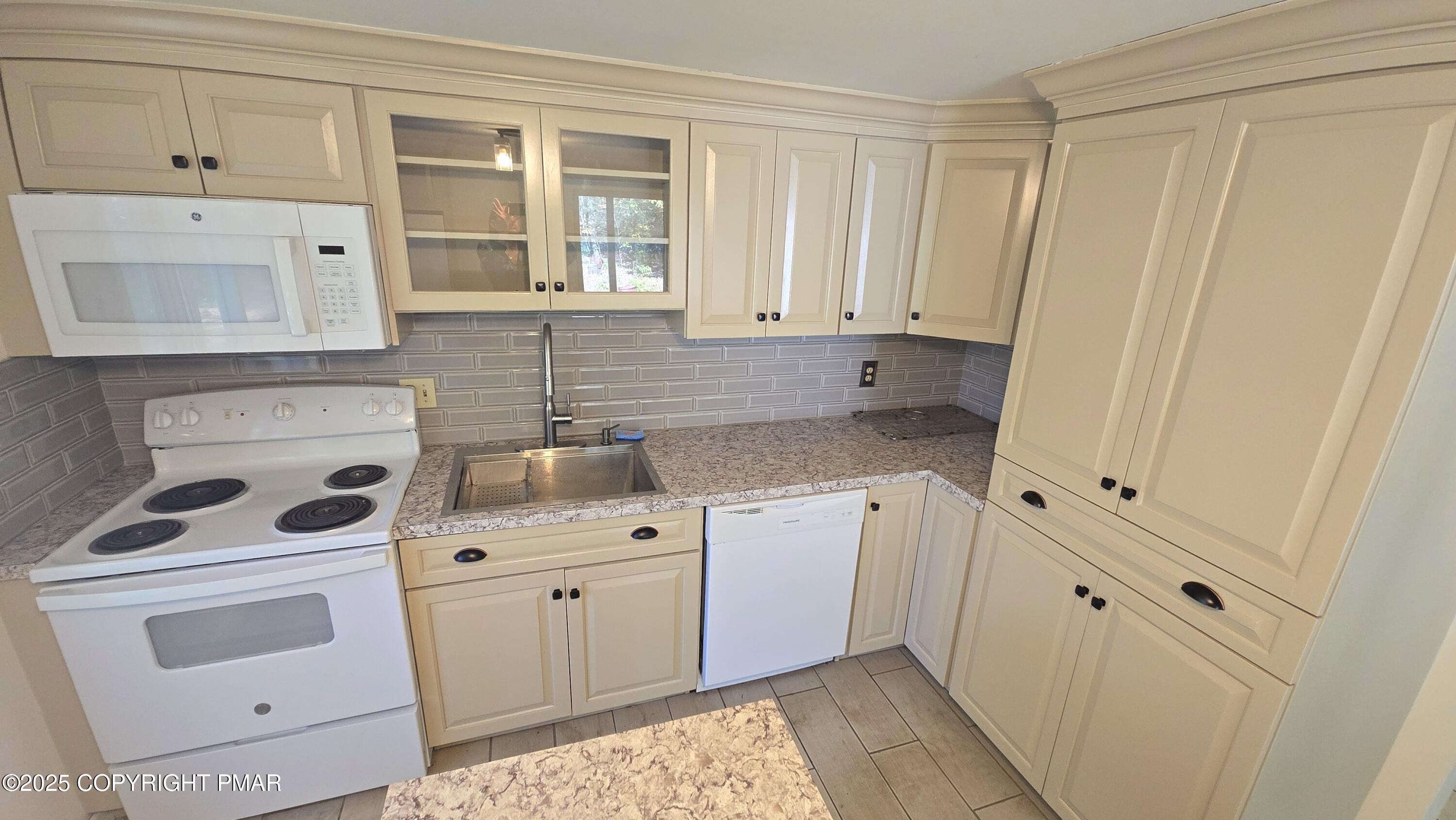 5550 Springhouse Lane Kunkletown, PA 18058 - Photo 11 of 41 a kitchen with white cabinets and white appliances