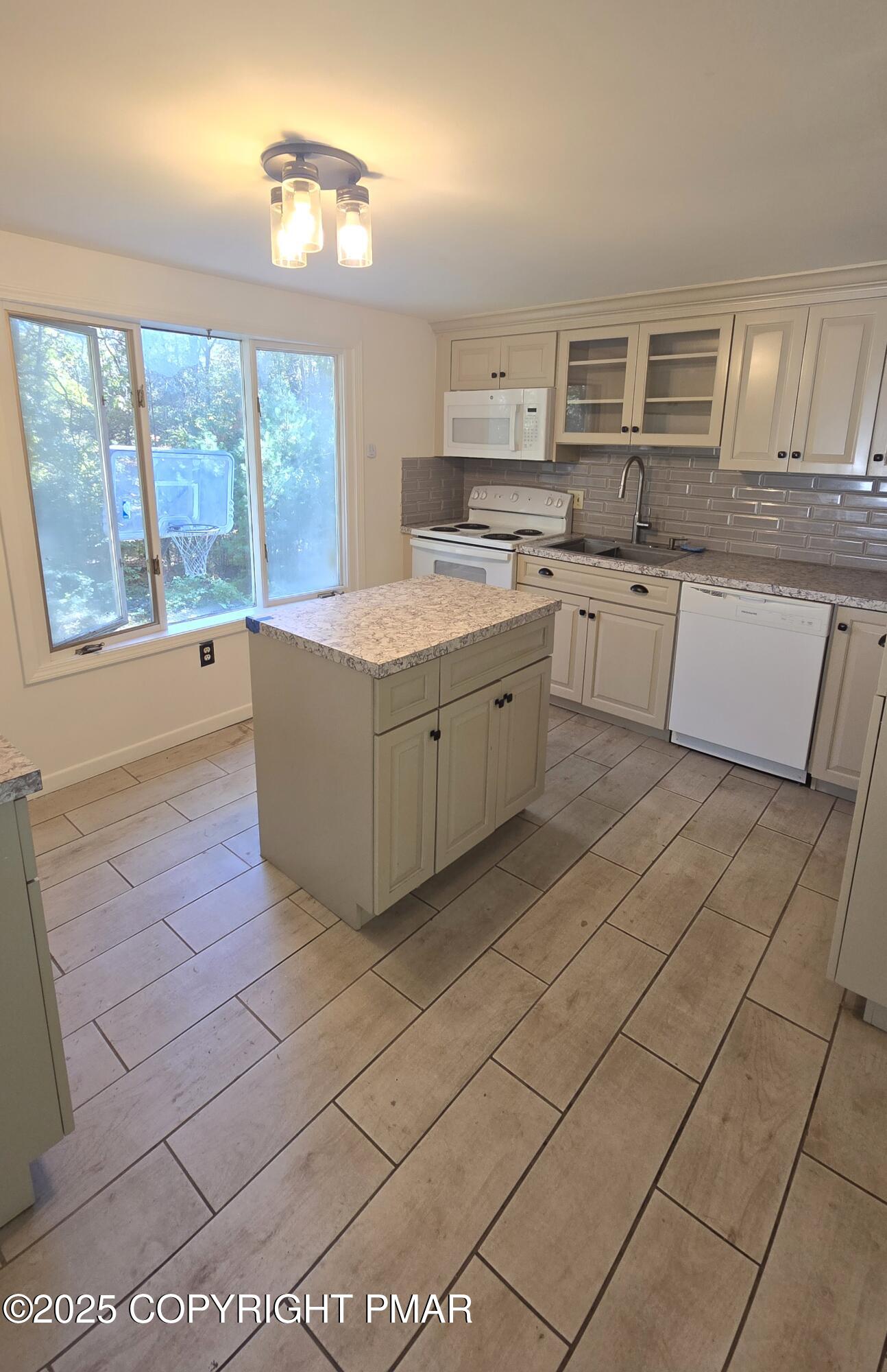 5550 Springhouse Lane Kunkletown, PA 18058 - Photo 16 of 41 a kitchen with stainless steel appliances granite countertop a stove a sink and a microwave