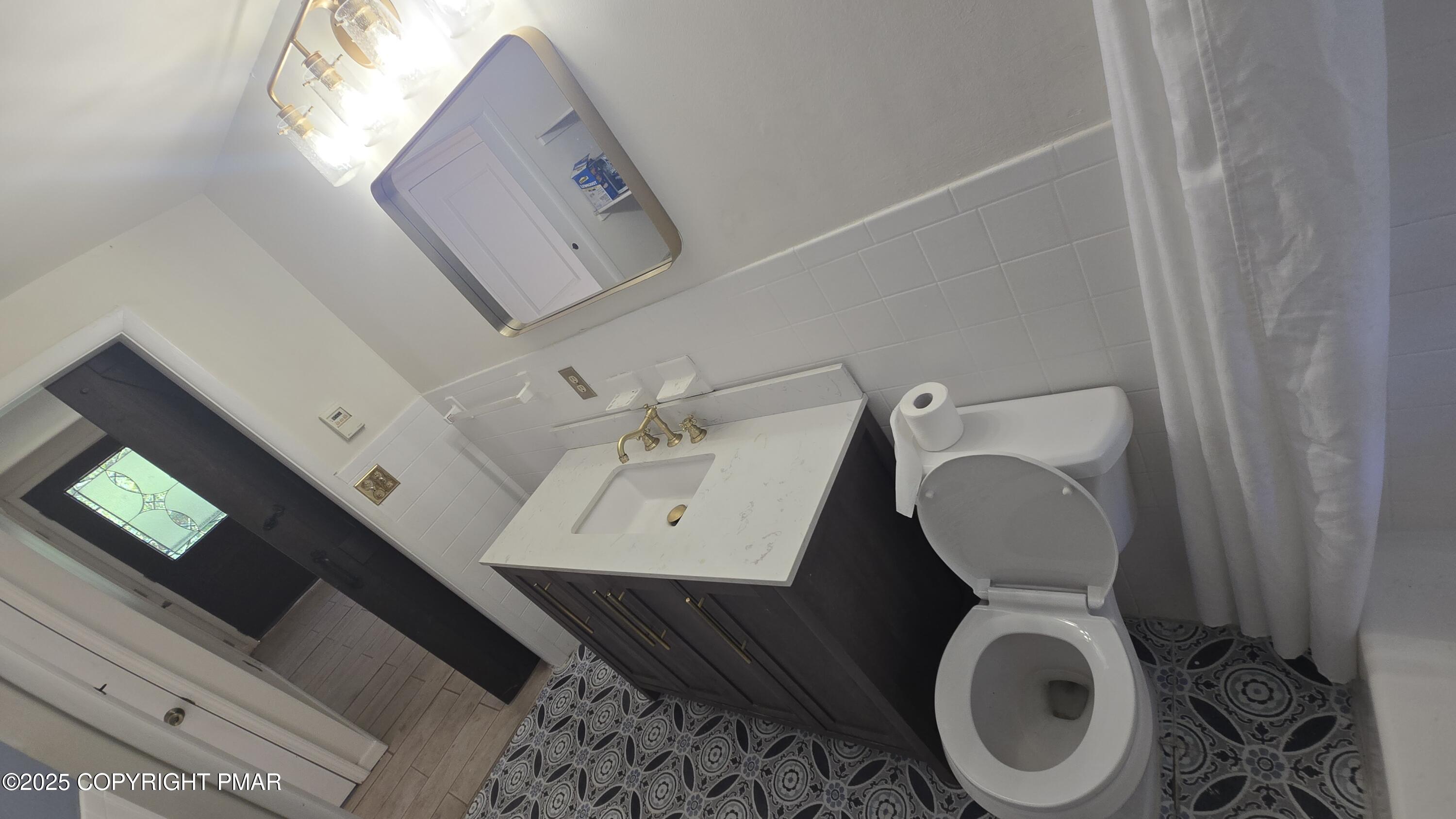 5550 Springhouse Lane Kunkletown, PA 18058 - Photo 21 of 41 a bathroom with a toilet a sink and mirror