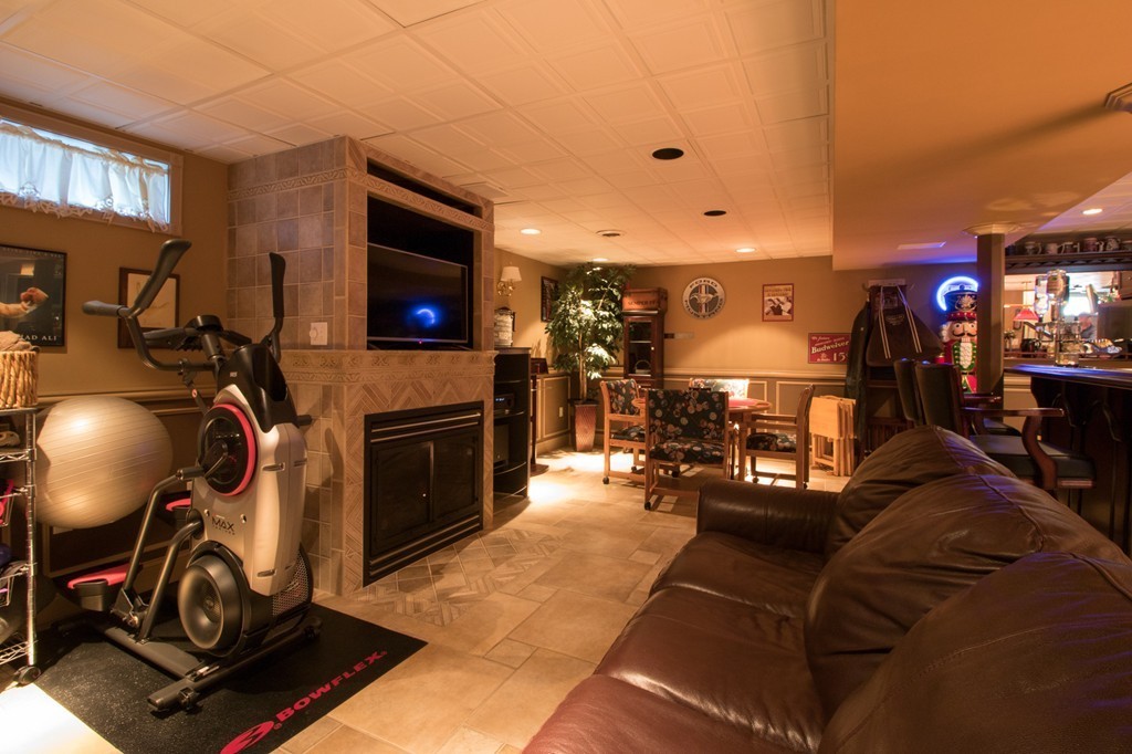 152 Carter Street Fall River, MA 02721 - Photo 25 of 30 a living room with furniture a flat screen tv and a fireplace