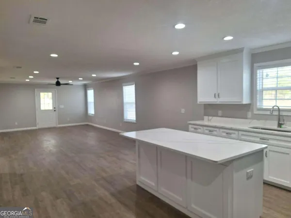 a kitchen with kitchen island a sink stove and refrigerator