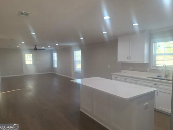 a bathroom with a granite countertop toilet a sink and bathtub