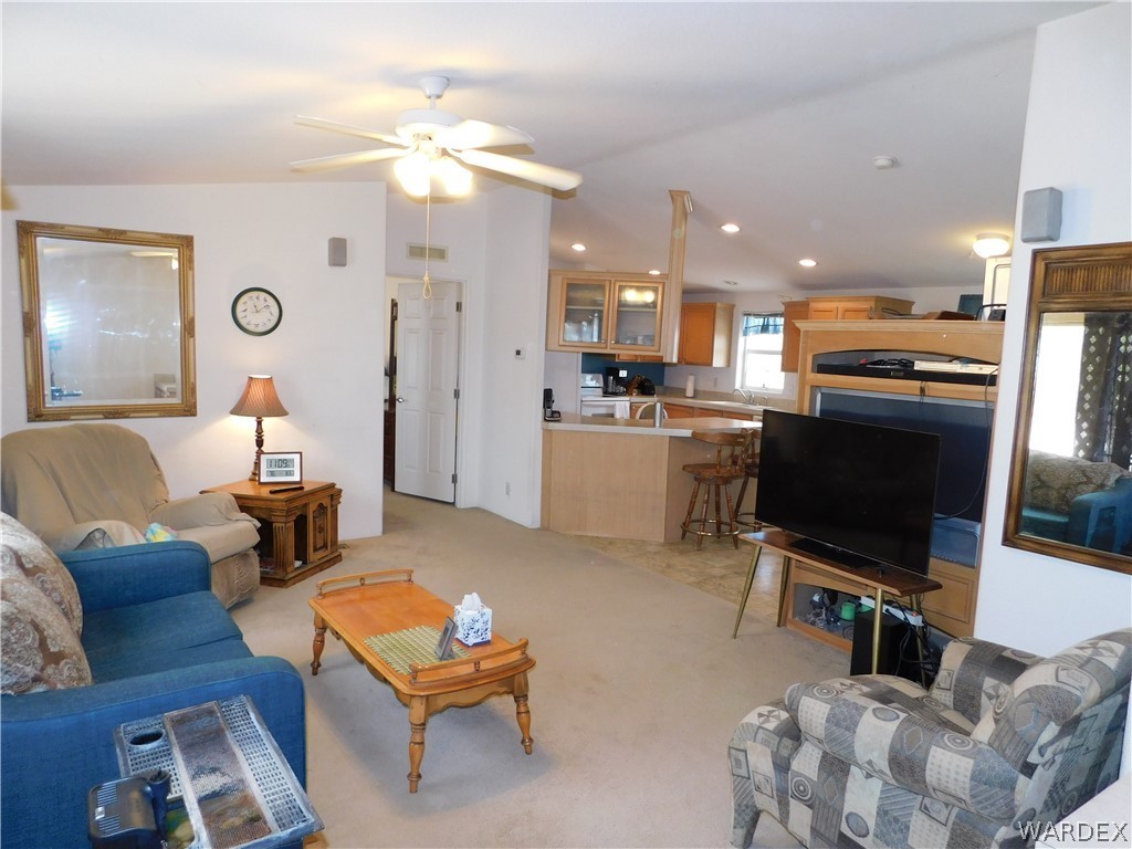 4810 Eloy Road Golden Valley, AZ 86413 - Photo 13 of 35 a living room with furniture a flat screen tv and kitchen view