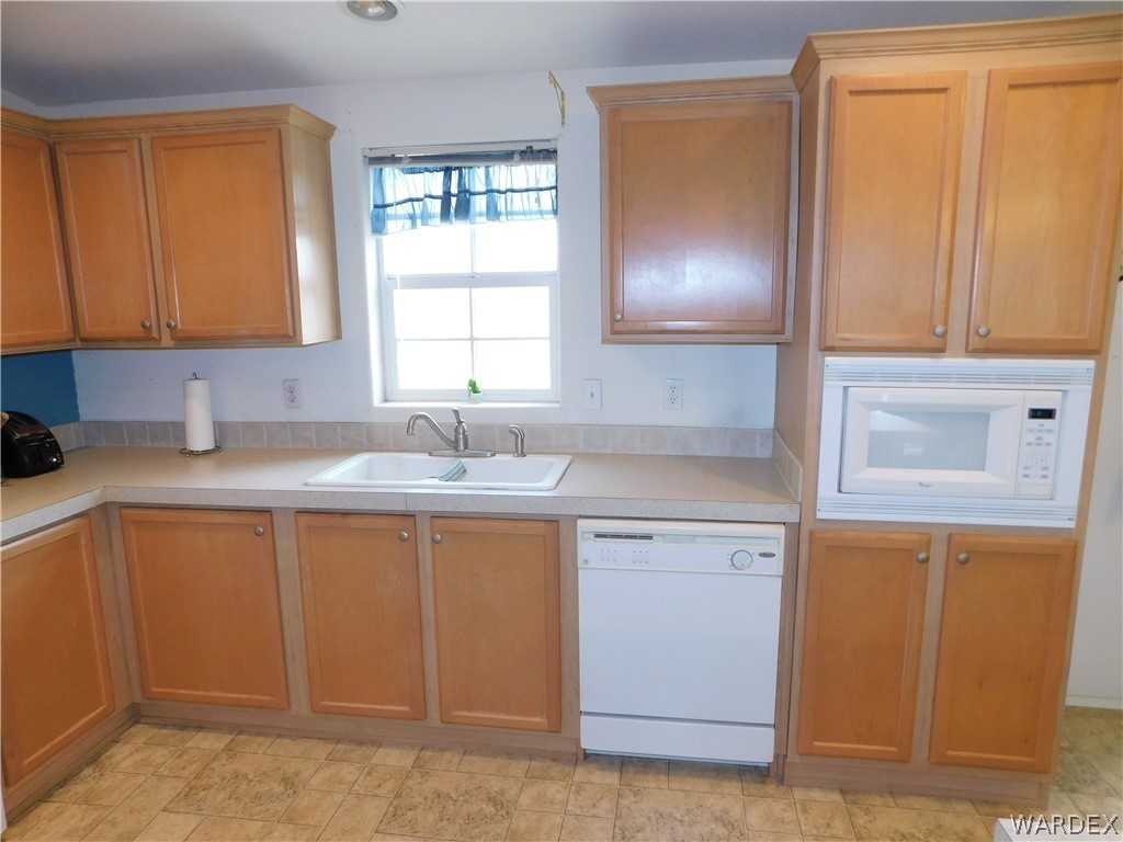 4810 Eloy Road Golden Valley, AZ 86413 - Photo 20 of 35 a kitchen with a sink cabinets and a window