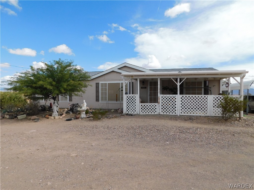 4810 Eloy Road Golden Valley, AZ 86413 - Photo 2 of 35 a front view of a house with a yard and garage