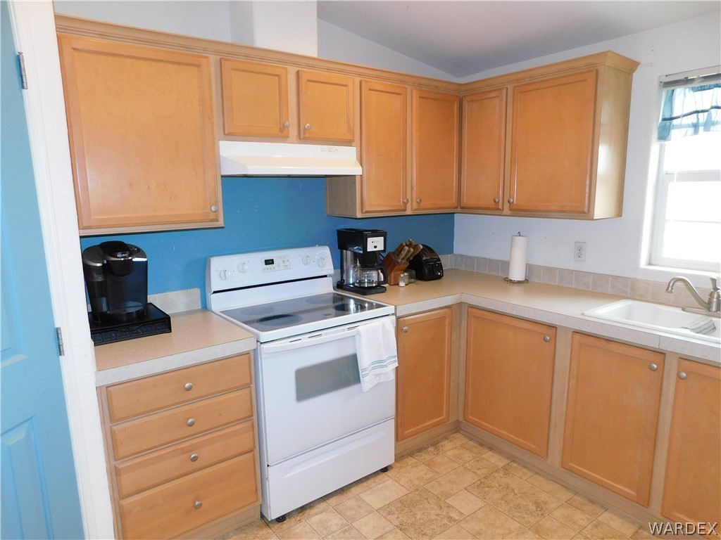 4810 Eloy Road Golden Valley, AZ 86413 - Photo 21 of 35 a kitchen with appliances cabinets and a sink