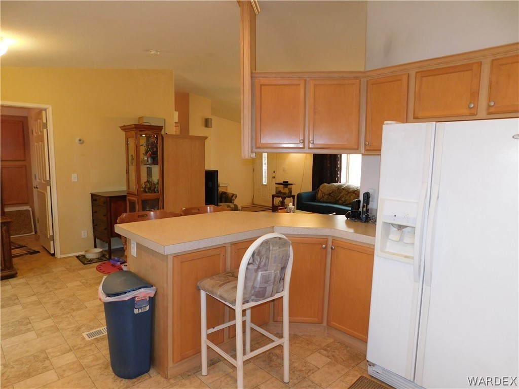 4810 Eloy Road Golden Valley, AZ 86413 - Photo 22 of 35 a kitchen with a refrigerator a stove and a microwave oven