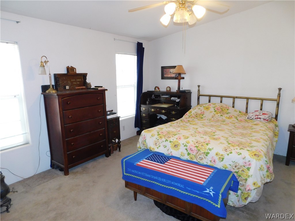 4810 Eloy Road Golden Valley, AZ 86413 - Photo 28 of 35 a bed sitting in a bedroom and dresser