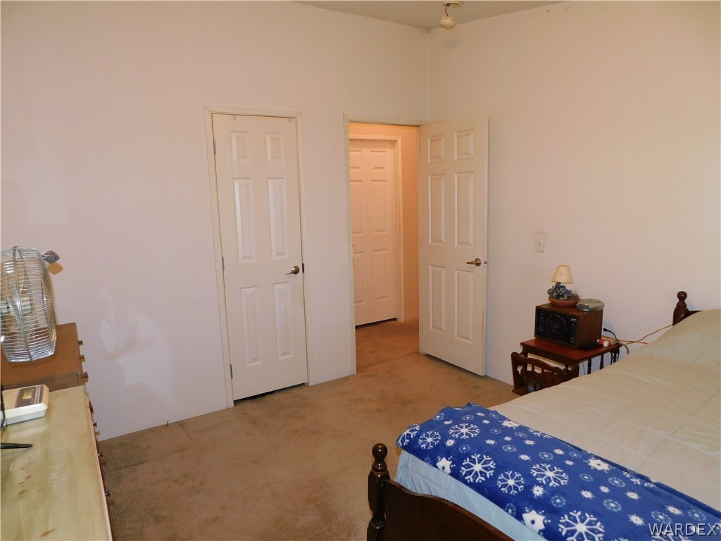 4810 Eloy Road Golden Valley, AZ 86413 - Photo 29 of 35 a bedroom with a bed and wooden floor