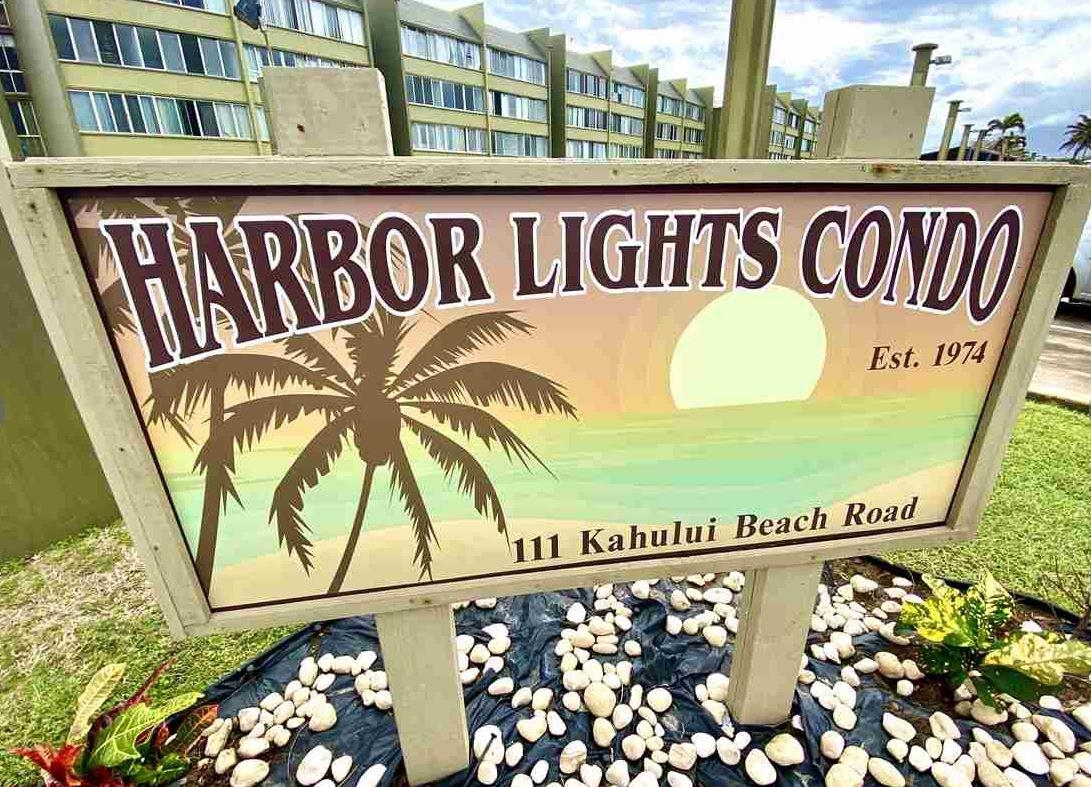 a street sign on a wall next to a road