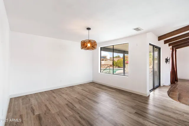 a view of room with window and wooden floor