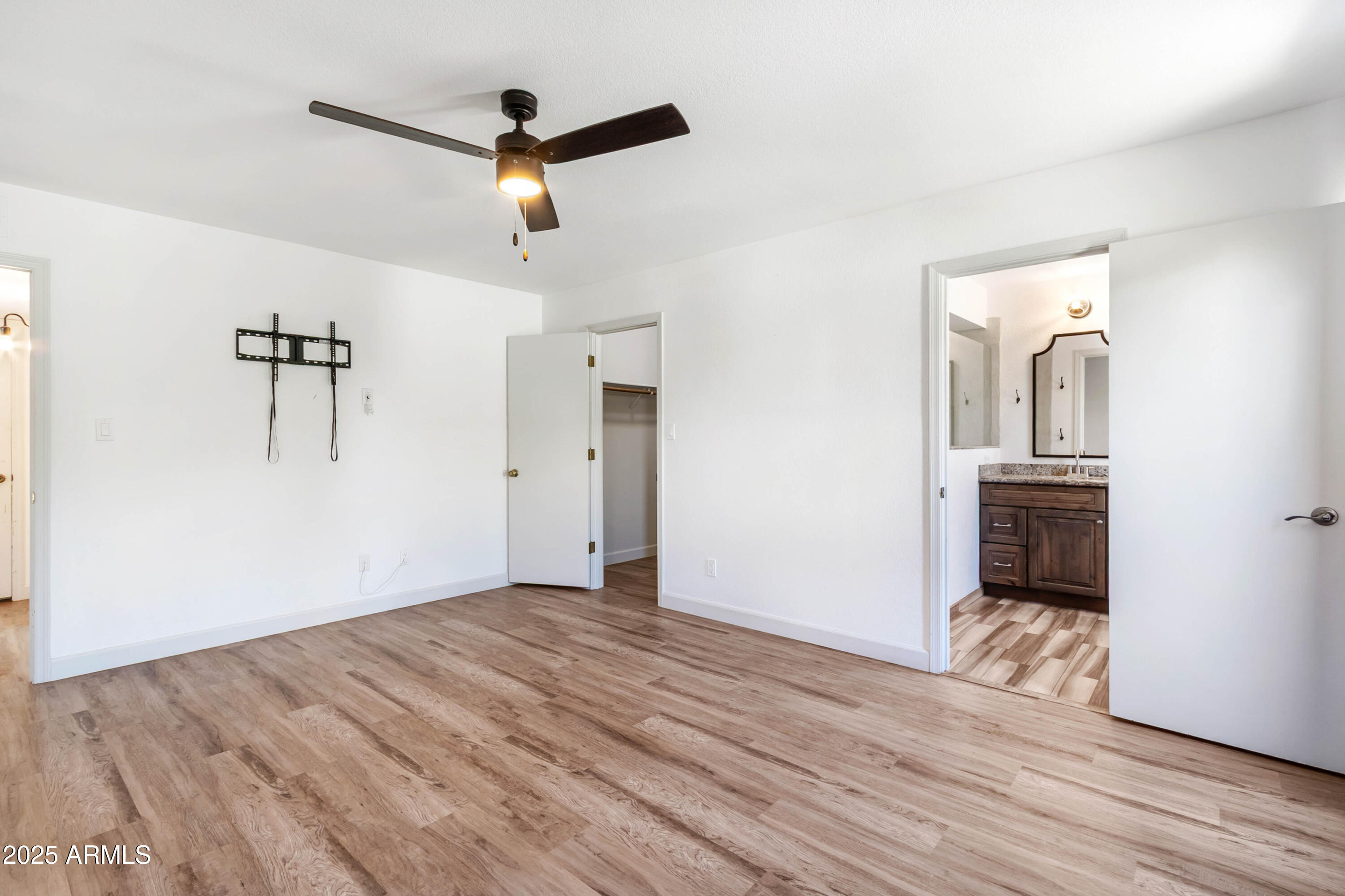 2228 East Jaeger Street Mesa, AZ 85213 - Photo 15 of 35 a view of empty room with wooden floor and ceiling fan