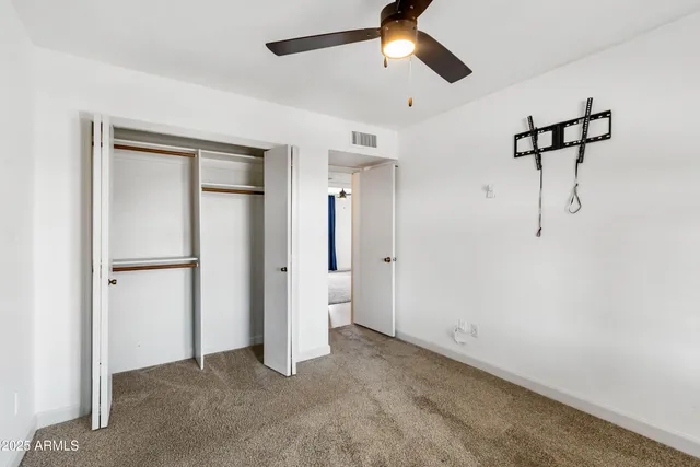 a view of empty room with ceiling fan