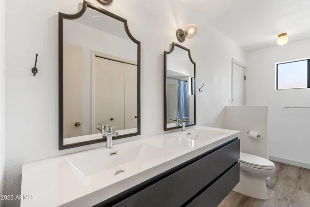 a bathroom with a double vanity sink and mirror