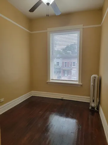 a view of a room with wooden floor and a window
