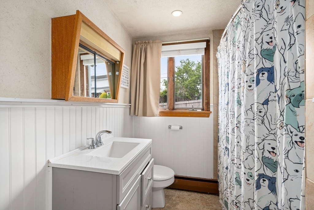 292 Rumney Road Revere, MA 02151 - Photo 11 of 24 a bathroom with a sink a toilet and a mirror