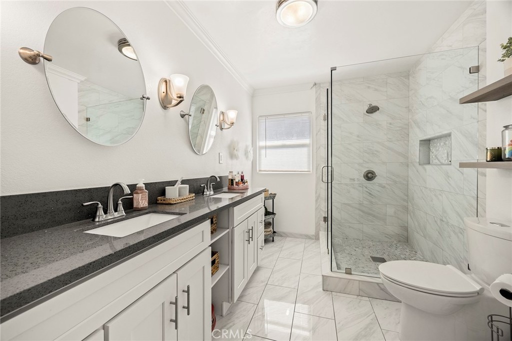 15914 West Road Whittier, CA 90603 - Photo 22 of 47 a bathroom with a granite countertop toilet sink and shower