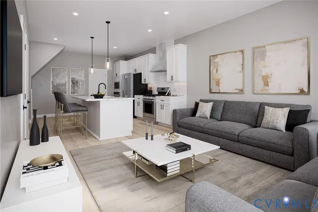 a living room with furniture and kitchen view