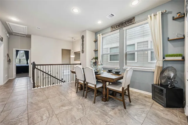 a dining room with furniture and windows