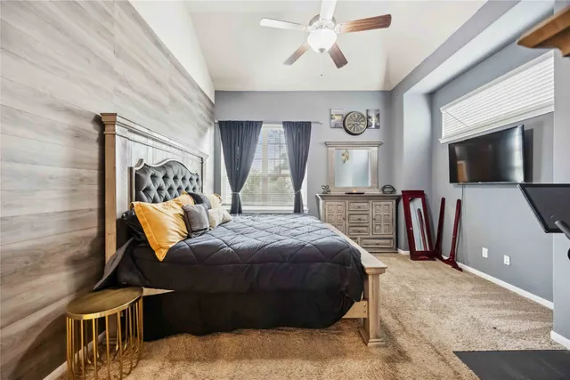 a bedroom with a bed window and a flat screen tv