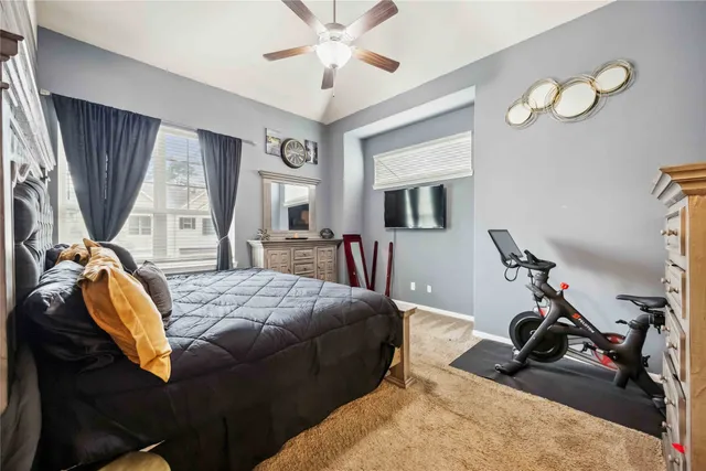 a bed room with a bed mirror and a window